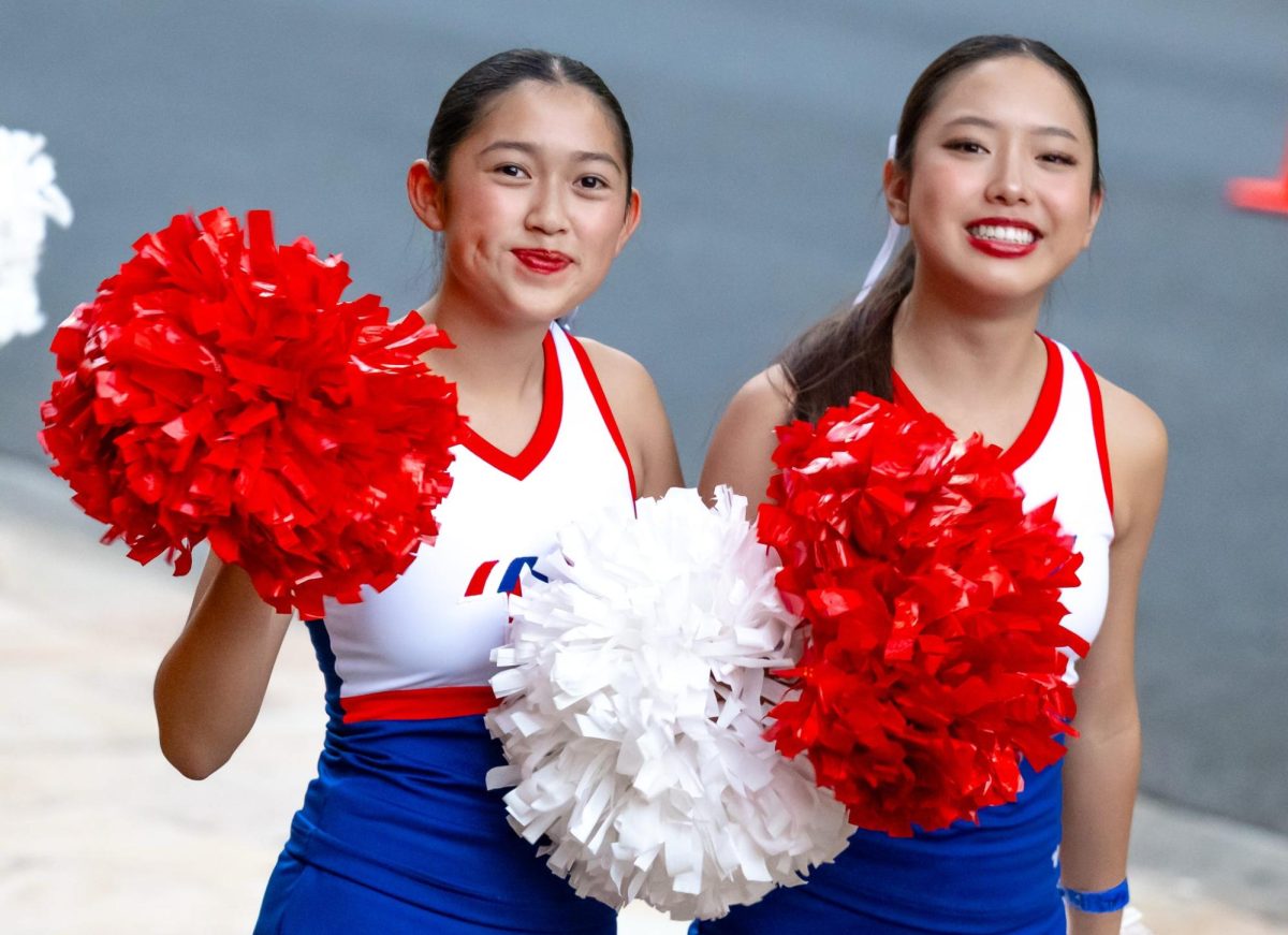 Freshman Vera Tse and Junior Evelyn Chun dance in the Pearl Harbor Memorial Day Parade. Photo courtesy of Kendal Houck | Used with persmission