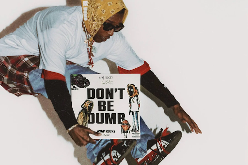 A$AP Rocky leaps in the air while holding his album cover. Photo courtesy of Rolling Stone