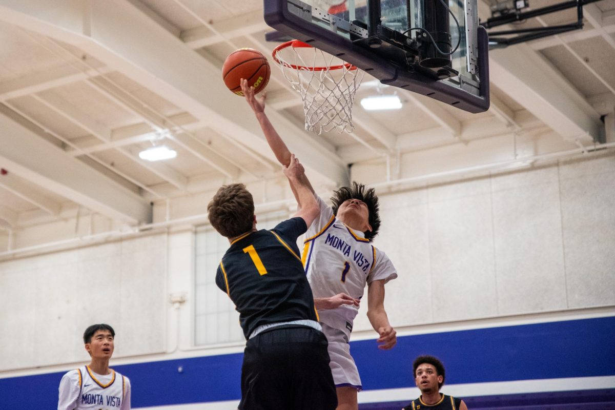 Sophomore and small forward Ethan Lin gets fouled by the opposing player while attempting to lay up the ball. Photo | Angela Poon