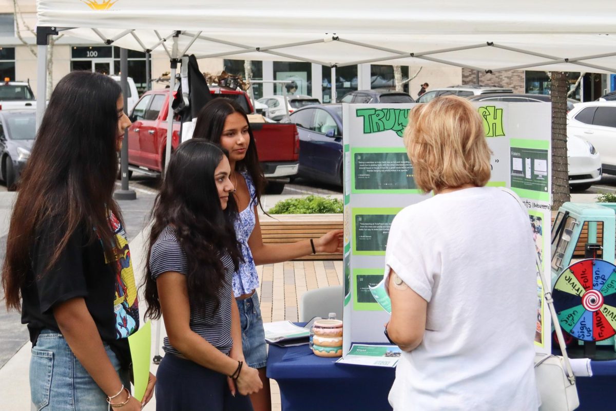 High schoolers promote their nonprofit Truly Fresh to fairgoers, which donates excess produce to any locals in need. Photo | Shreejay Arja
