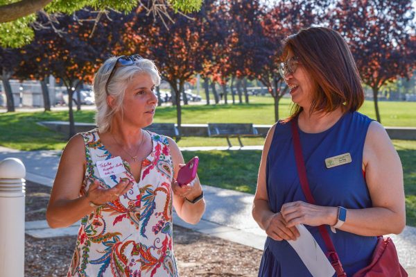 FUHSF President Eva Peng converses with Educational Options English teacher Tabitha Kappeler-Hurley while exploring the student booths. 